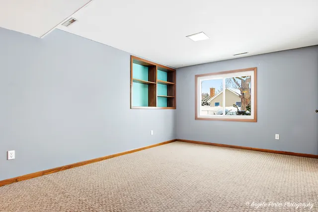 an empty room with windows and closet