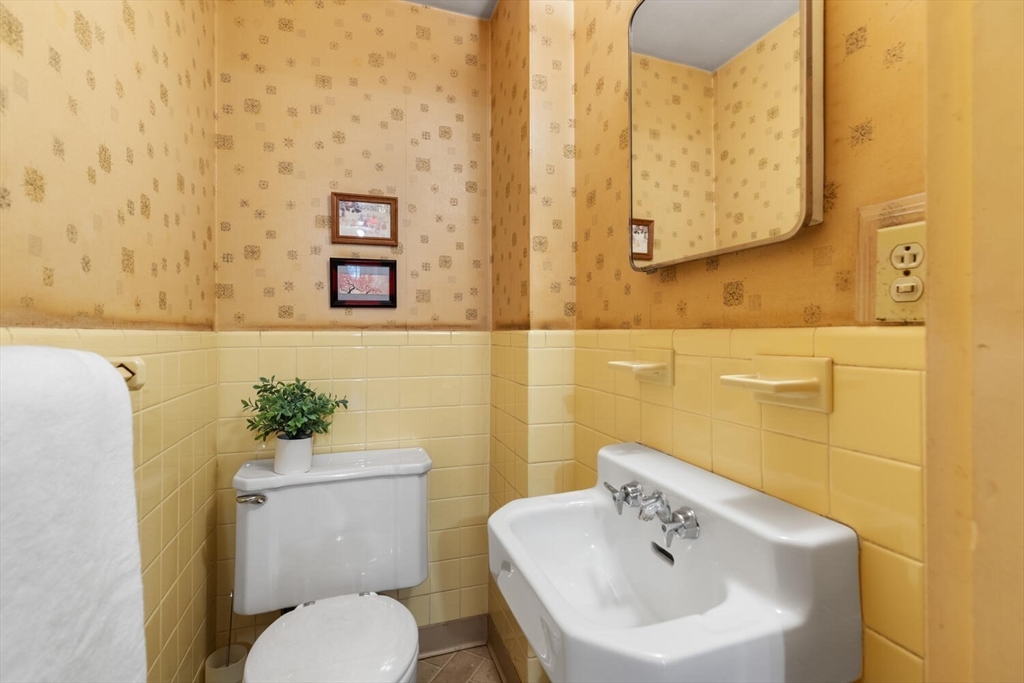 19 Crescent Road Lexington, MA 02421 - Photo 12 of 29 a bathroom with a toilet sink and mirror