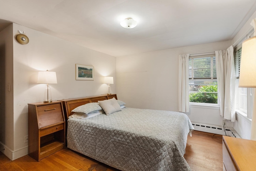 19 Crescent Road Lexington, MA 02421 - Photo 20 of 29 a bedroom with a bed a lamp and a window
