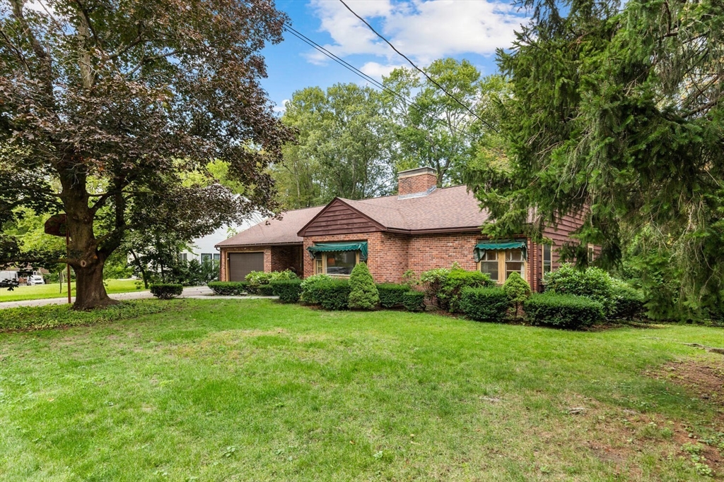 19 Crescent Road Lexington, MA 02421 - Photo 3 of 29 a front view of a house with a garden