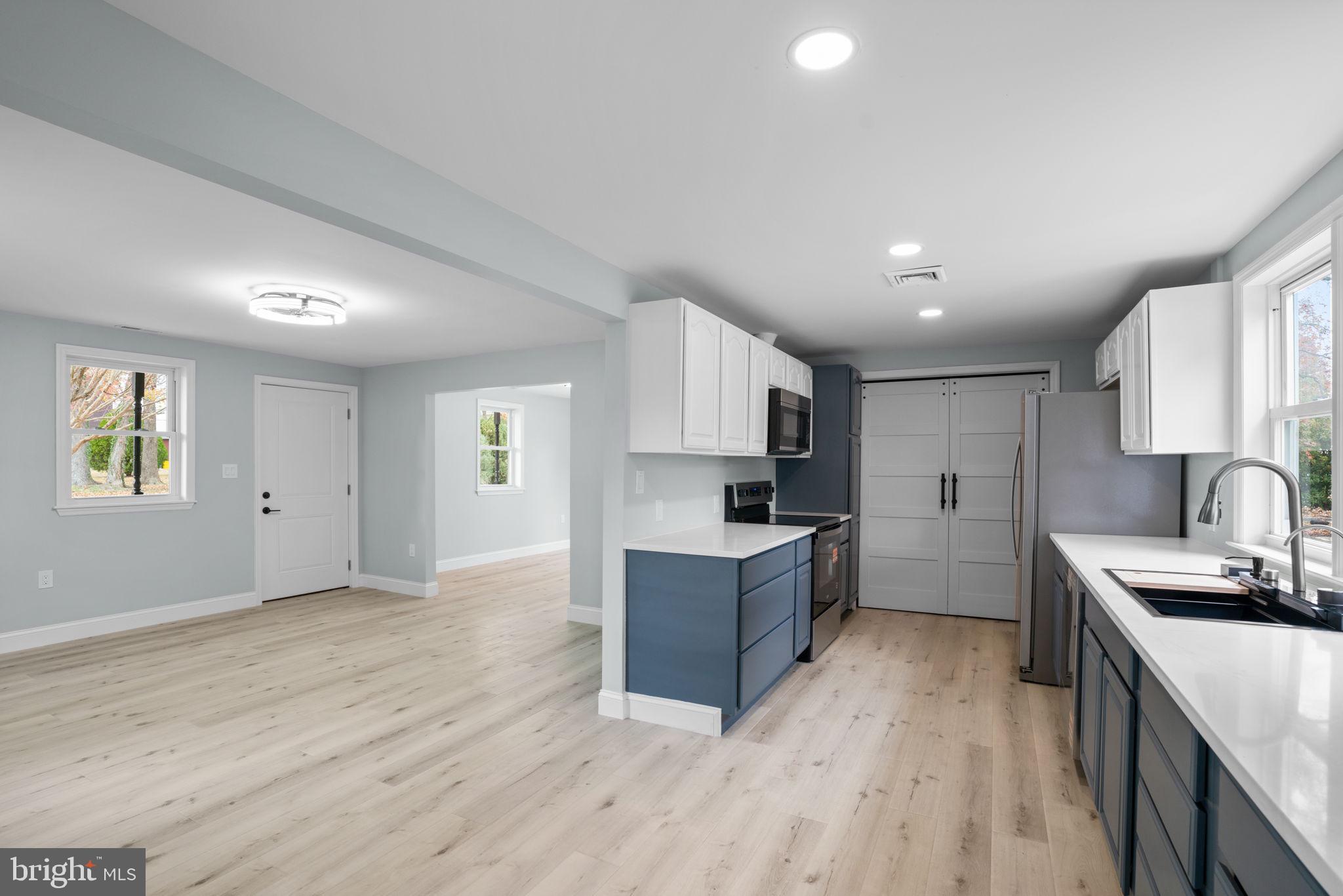 2636 Haddaway Road Sparrows Point, MD 21219 - Photo 12 of 43 a kitchen with granite countertop a sink cabinets and wooden floor
