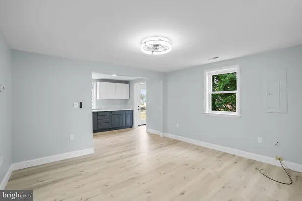 an empty room with windows and cabinet