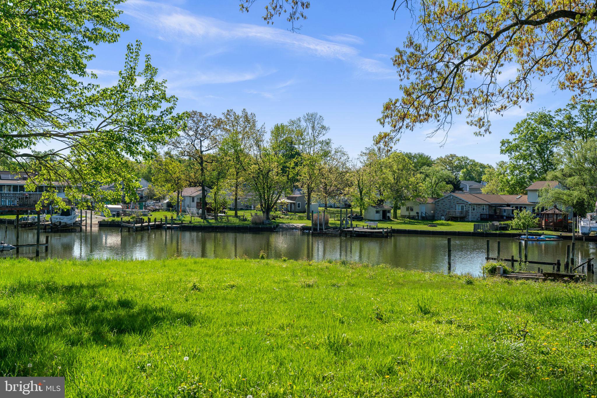2636 Haddaway Road Sparrows Point, MD 21219 - Photo 32 of 43 a view of a lake with a house in the background