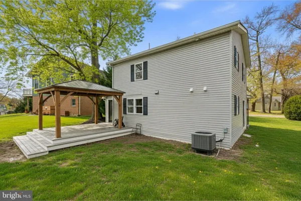 a view of a house with backyard and a tree
