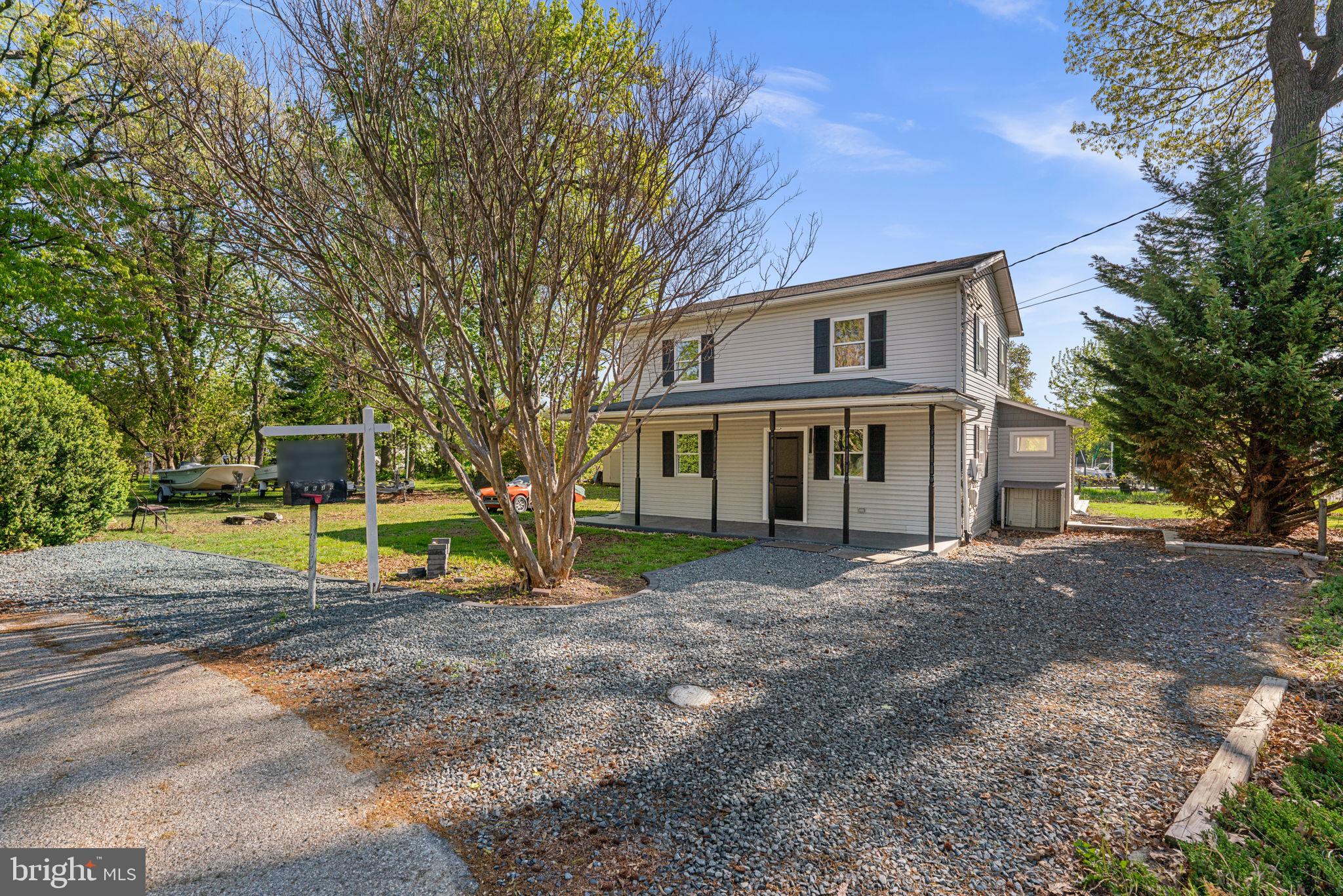 2636 Haddaway Road Sparrows Point, MD 21219 - Photo 40 of 43 a view of a house with a large tree and a yard