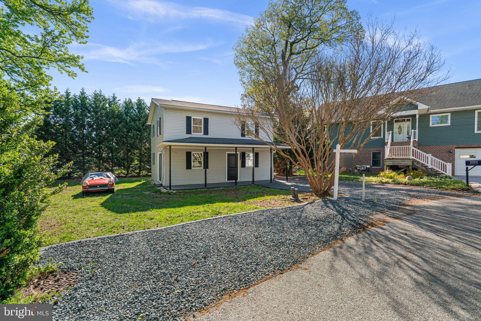 2636 Haddaway Road Sparrows Point, MD 21219 - Photo 42 of 43 a front view of a house with a yard and garage