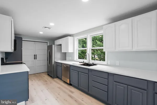 a kitchen with a sink stove and cabinets