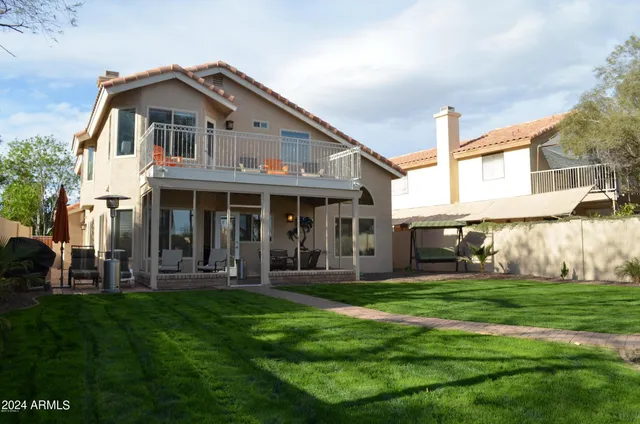 a kitchen with stainless steel appliances kitchen island granite countertop a sink a stove and a refrigerator