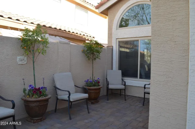 a view of a swimming pool with an outdoor seating and a yard