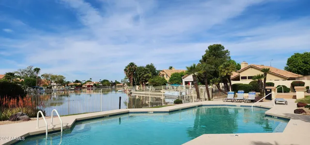 a view of a house with a yard balcony and sitting area