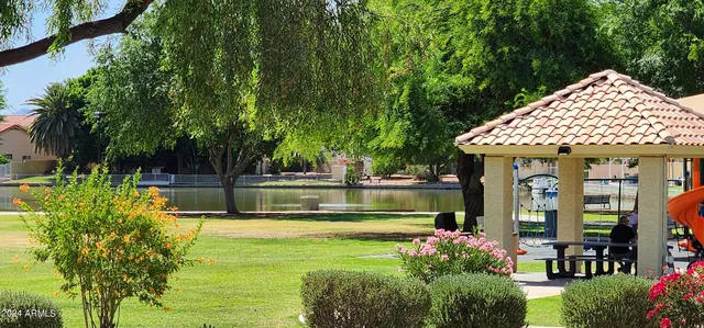 a view of swimming pool with sitting area and garden