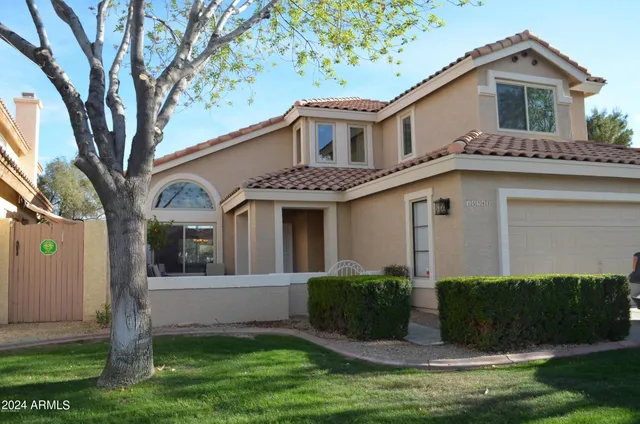 a front view of a house with a yard and porch