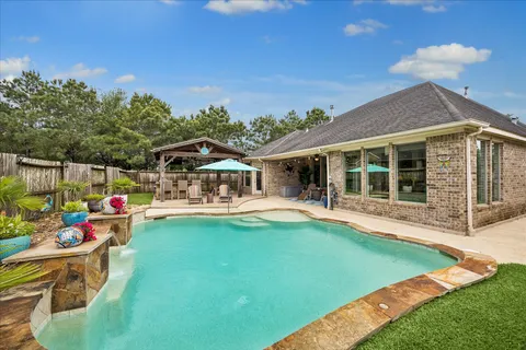 a view of a house with swimming pool and porch with furniture