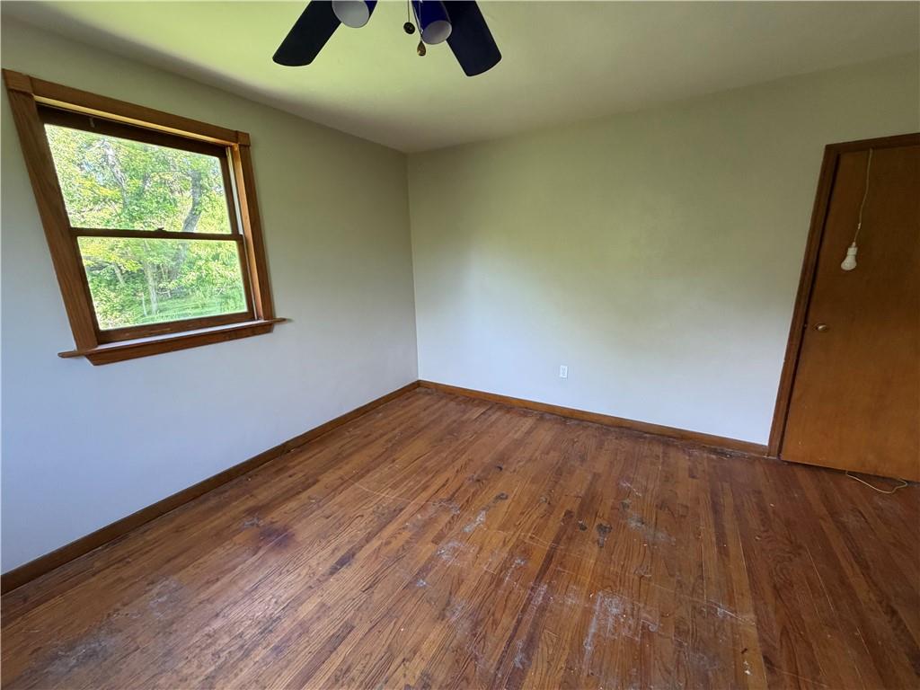 3079 Mt Troy Road Pittsburgh, PA 15212 - Photo 16 of 30 an empty room with wooden floor chandelier fan and windows