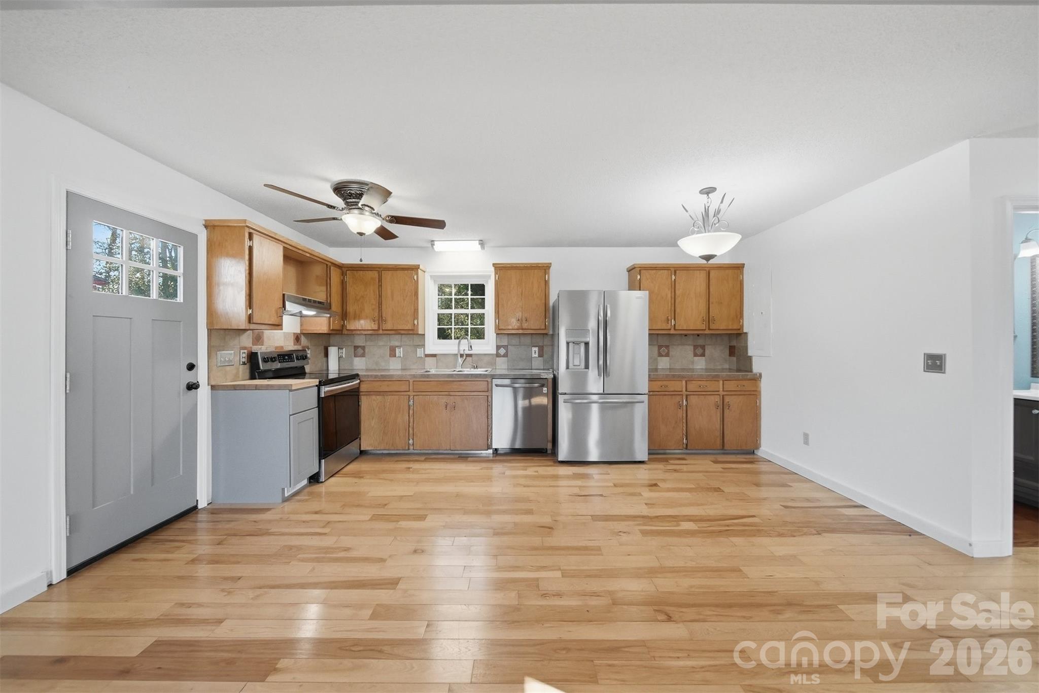 4771 Petra Mill Road Granite Falls, NC 28630 - Photo 20 of 46 a kitchen with stainless steel appliances granite countertop a refrigerator and a sink