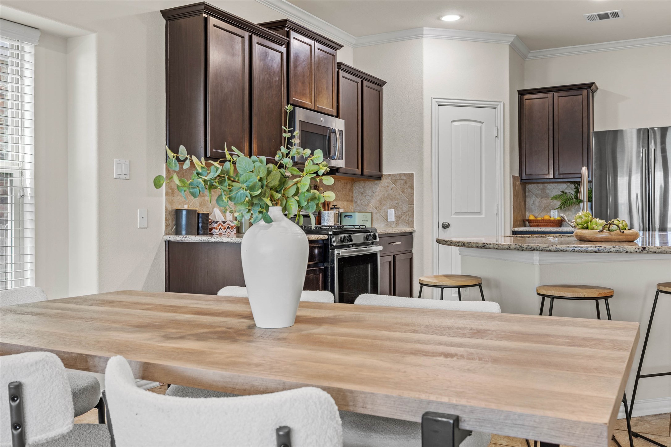 536 Rancho Verde Drive Leander, TX 78641 - Photo 11 of 37 a dining table with chairs and cabinets
