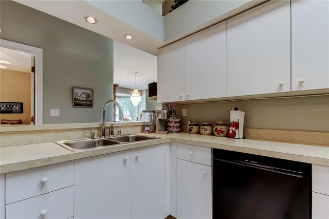 a kitchen with a sink cabinets and a window