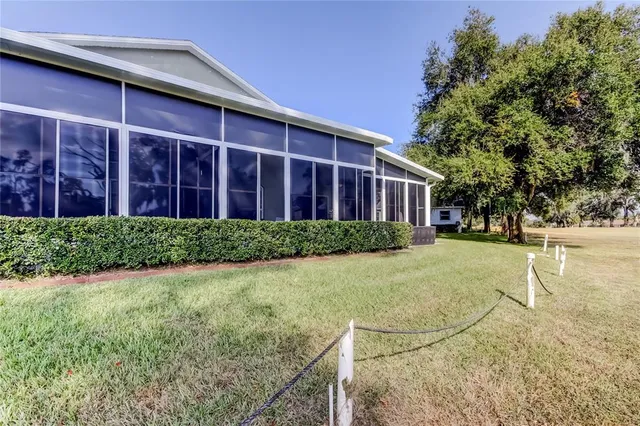 a view of a house with backyard and trees