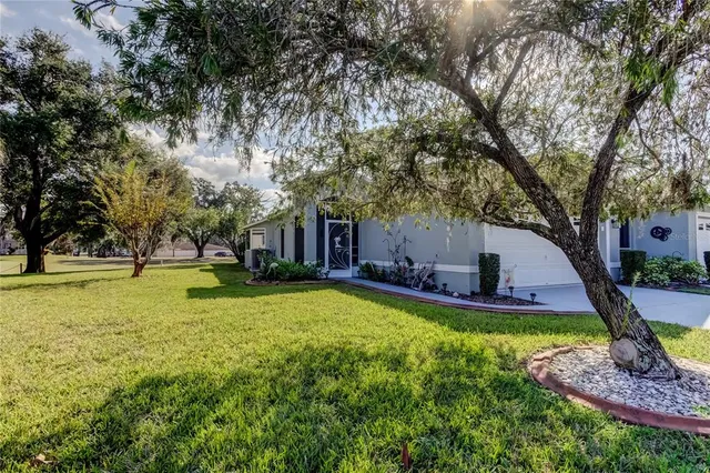 a view of a house with pool and a yard