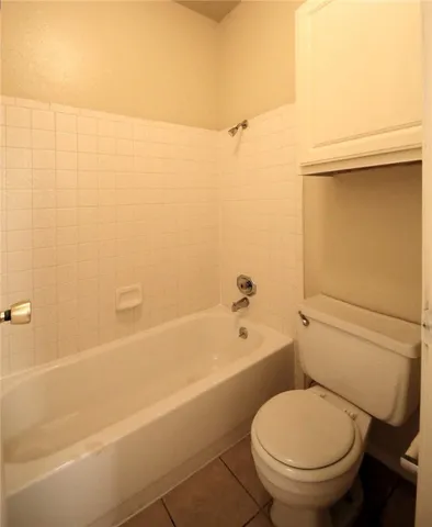 a bathroom with a toilet and a bathtub