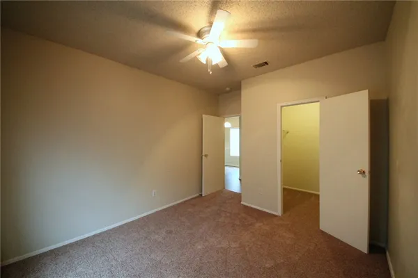 a view of a livingroom with a chandelier fan