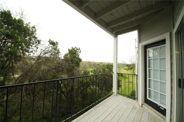 a view of a balcony with wooden floor