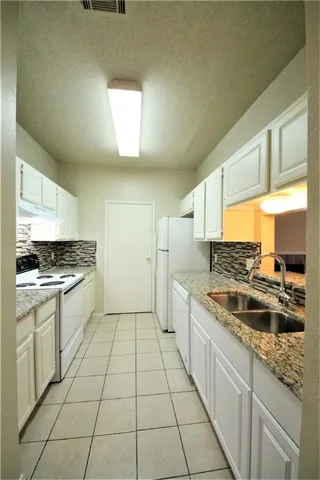 a kitchen with a sink and cabinets