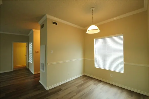 a view of a room with wooden floor and windows