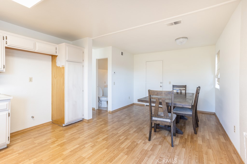8424 Bayberry Road Rancho Cucamonga, CA 91730 - Photo 12 of 27 a view of a dining room with furniture and wooden floor