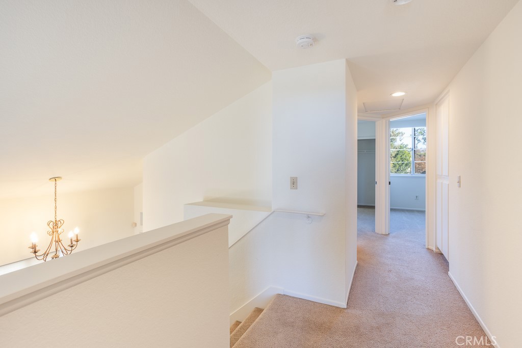 8424 Bayberry Road Rancho Cucamonga, CA 91730 - Photo 15 of 27 a view of a hallway with wooden floor and a living room