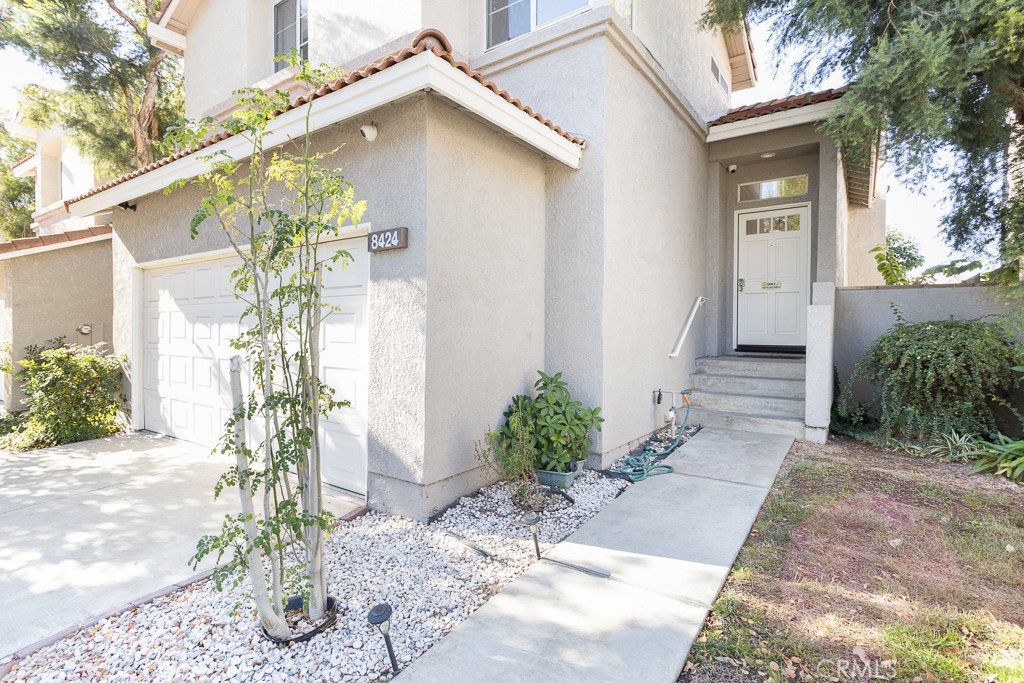 8424 Bayberry Road Rancho Cucamonga, CA 91730 - Photo 2 of 27 a front view of a house with a yard