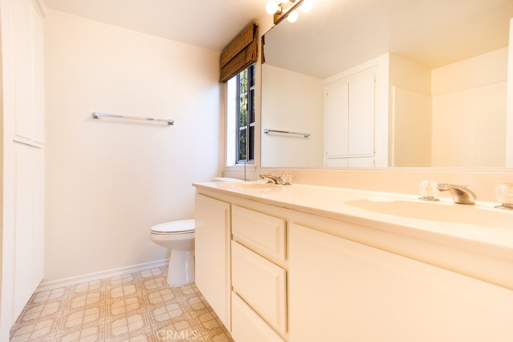 8424 Bayberry Road Rancho Cucamonga, CA 91730 - Photo 21 of 27 a bathroom with a sink a toilet and a mirror