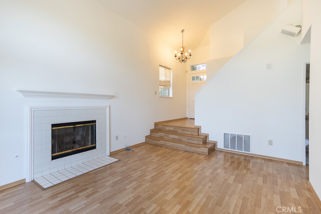 8424 Bayberry Road Rancho Cucamonga, CA 91730 - Photo 4 of 27 a view of an empty room with wooden floor and a window
