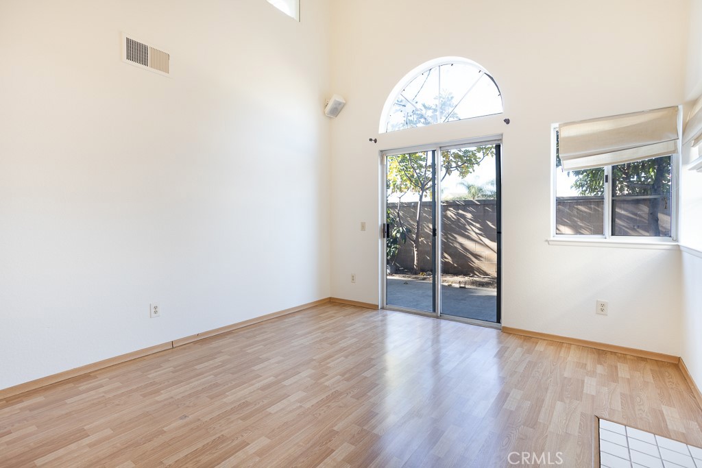 8424 Bayberry Road Rancho Cucamonga, CA 91730 - Photo 5 of 27 an empty room with wooden floor and windows