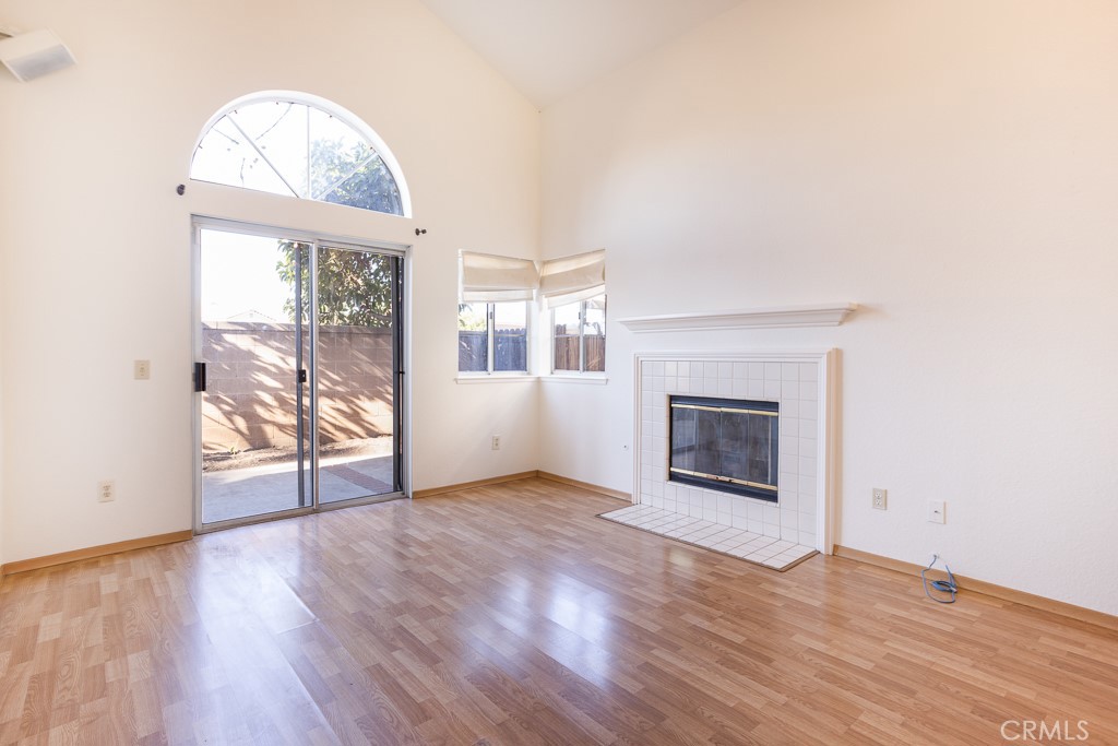 8424 Bayberry Road Rancho Cucamonga, CA 91730 - Photo 6 of 27 an empty room with wooden floor fireplace and windows