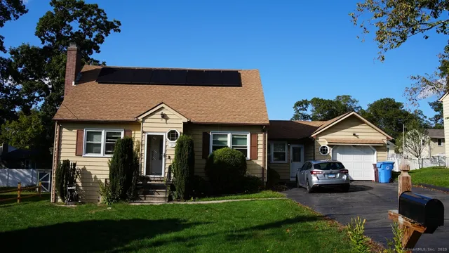 a front view of a house with a garden