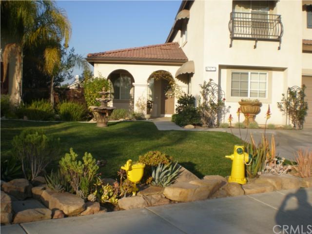 17872 Grandis Court Riverside, CA 92503 - Photo 1 of 1 a front view of a house with garden and lake view