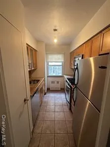 a kitchen with a refrigerator and a sink