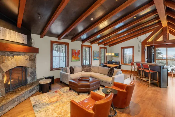 a living room with furniture a fireplace and a table