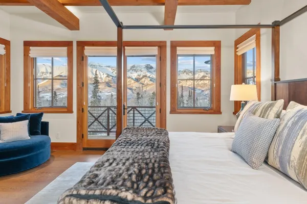 a bedroom with furniture and large windows