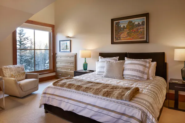 a bedroom with a bed and glass window