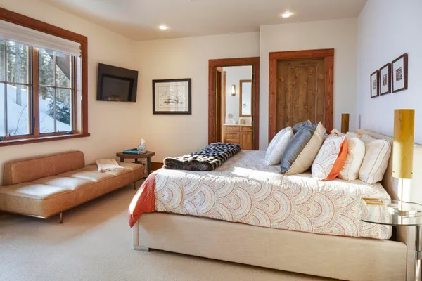 a bedroom with a bed couch and window