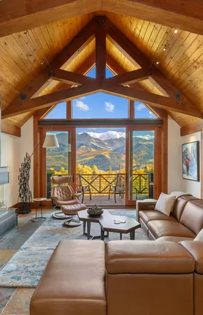 a living room with furniture and large windows