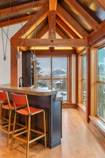 a dining room with furniture and large windows