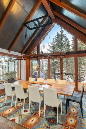 a dining room with furniture a chandelier and a rug
