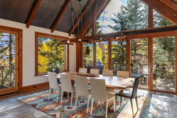 a view of a dining room with furniture large windows and wooden floor