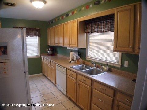 3036 Rosedale Boulevard Louisville, KY 40220 - Photo 4 of 14 Updated Kitchen with light maple cabinets, ceramic tile floors, and white appliances.