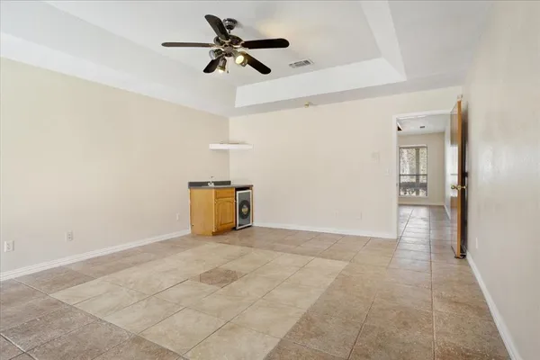 a view of a livingroom with a ceiling fan and wooden floor