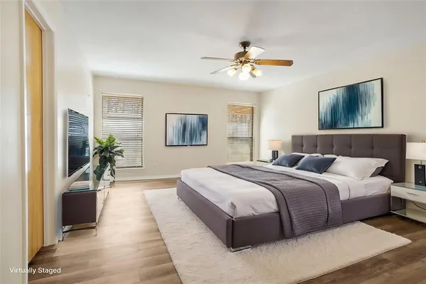 a bedroom with a large bed and a chandelier
