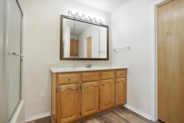 a bathroom with a sink a mirror and a vanity